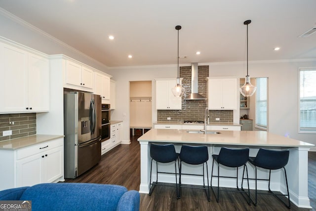 kitchen featuring stainless steel fridge with ice dispenser, decorative light fixtures, white cabinets, and wall chimney exhaust hood