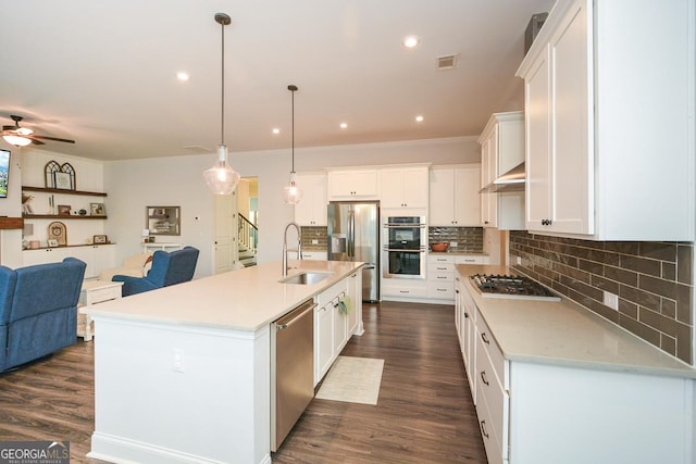 kitchen with hanging light fixtures, sink, white cabinetry, a center island with sink, and stainless steel appliances