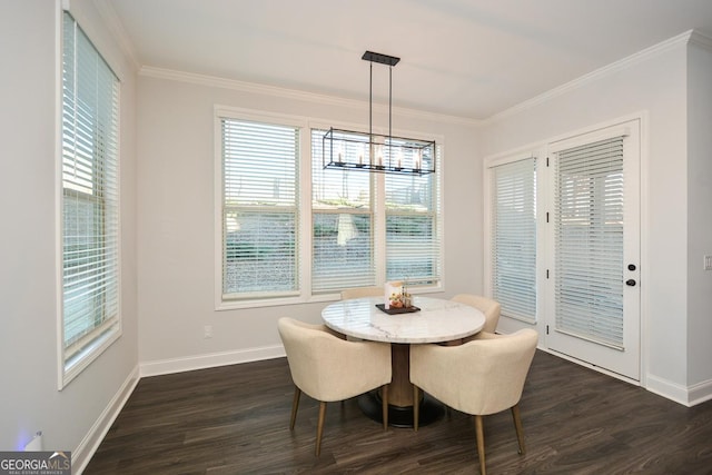 dining space featuring dark hardwood / wood-style floors, crown molding, and an inviting chandelier