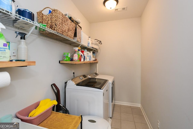 laundry room with light tile patterned floors and washer and dryer