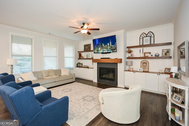 living room with ceiling fan, crown molding, and dark hardwood / wood-style floors