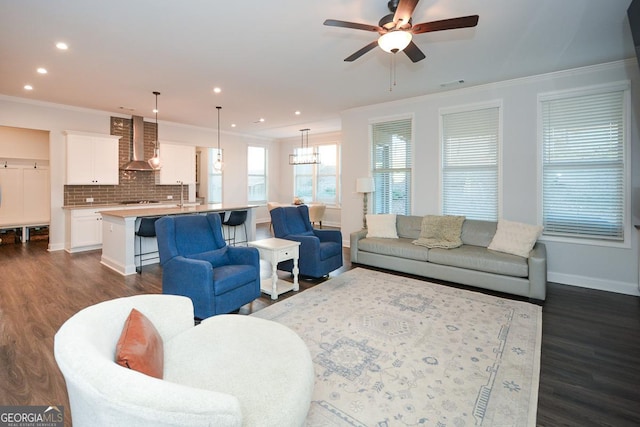 living room featuring ceiling fan, crown molding, and dark hardwood / wood-style floors