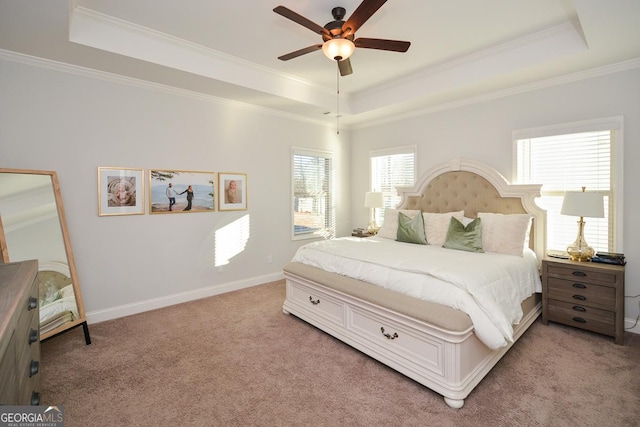 bedroom with light colored carpet, ceiling fan, and a raised ceiling