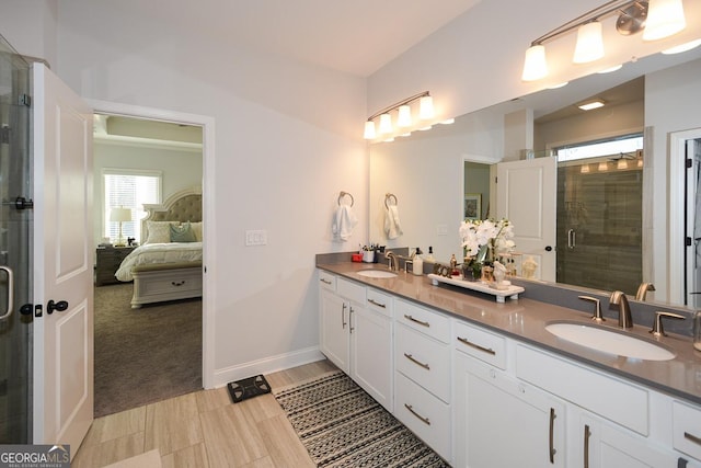 bathroom with vanity and a shower with shower door