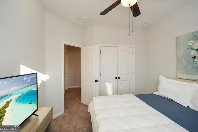 carpeted bedroom with a closet and ceiling fan