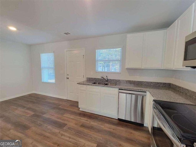 kitchen featuring dark wood-type flooring, sink, white cabinetry, and appliances with stainless steel finishes