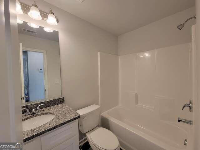 full bathroom with shower / bath combination, toilet, and vanity