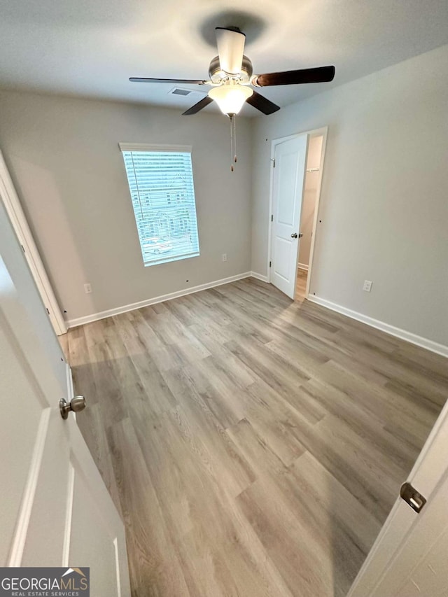 unfurnished bedroom with ceiling fan and light hardwood / wood-style floors