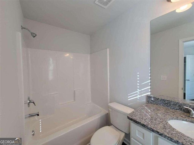 full bathroom featuring toilet, vanity, and tub / shower combination