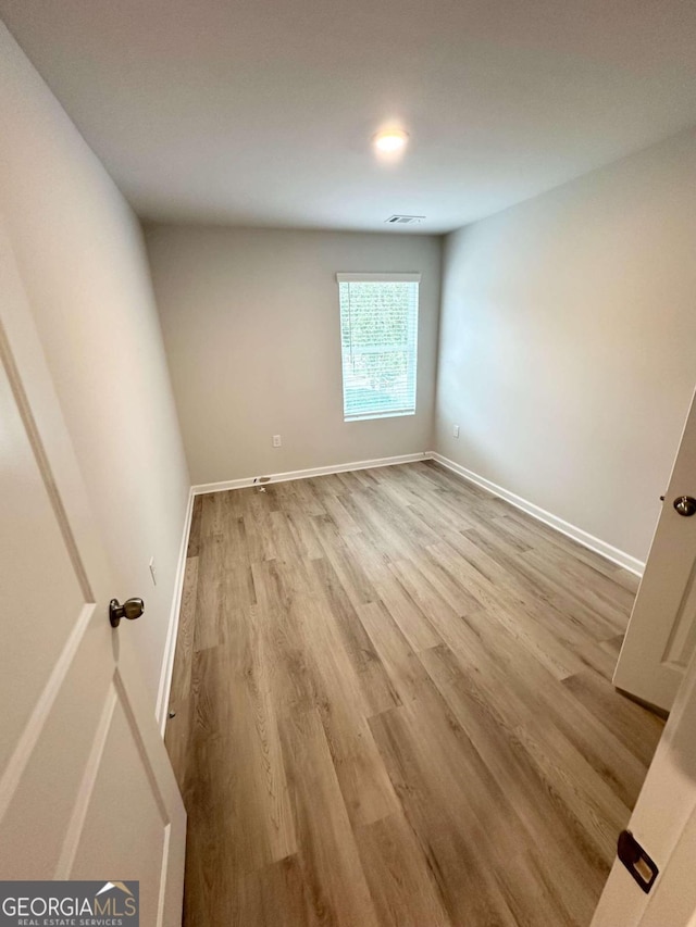 spare room with light hardwood / wood-style floors