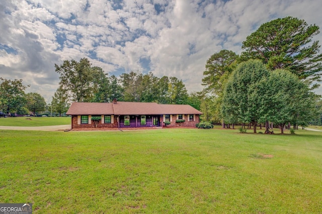 ranch-style home featuring a front yard