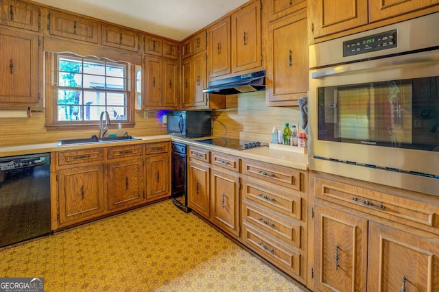 kitchen featuring sink, decorative backsplash, and black appliances