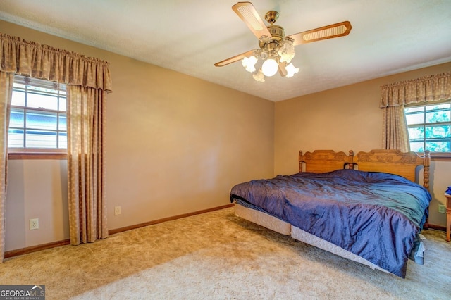 bedroom with multiple windows, carpet, and ceiling fan