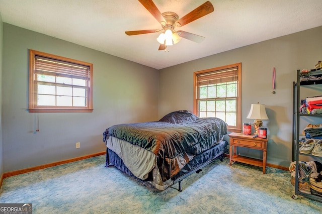 bedroom with ceiling fan and carpet