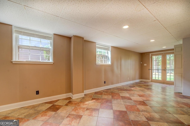 unfurnished room featuring french doors