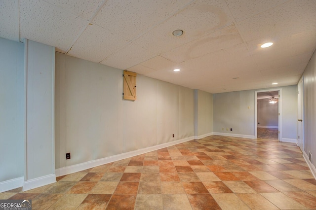 basement featuring a paneled ceiling