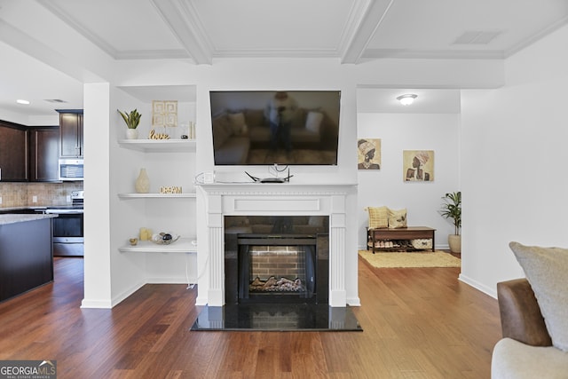 living room featuring beam ceiling, crown molding, and hardwood / wood-style floors