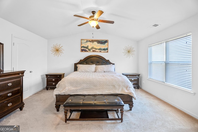 bedroom with ceiling fan, lofted ceiling, and light colored carpet