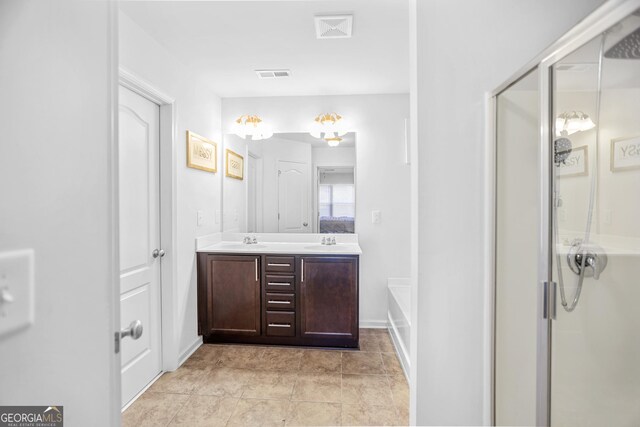 bathroom featuring shower with separate bathtub and vanity