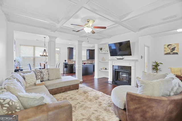 living room with coffered ceiling, ceiling fan, dark hardwood / wood-style floors, beam ceiling, and built in shelves