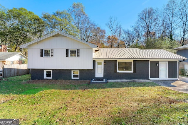 tri-level home with a front lawn