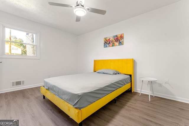 bedroom featuring ceiling fan and hardwood / wood-style flooring