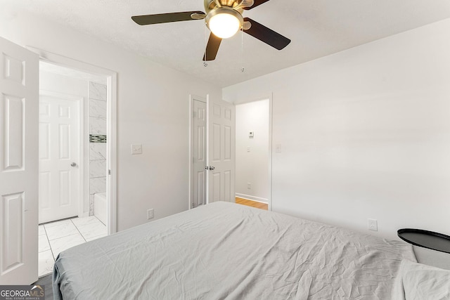 bedroom with ceiling fan and ensuite bath