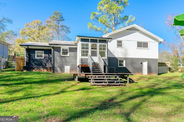 back of house featuring a sunroom and a yard