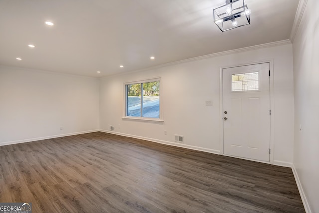 foyer entrance with dark hardwood / wood-style floors and ornamental molding