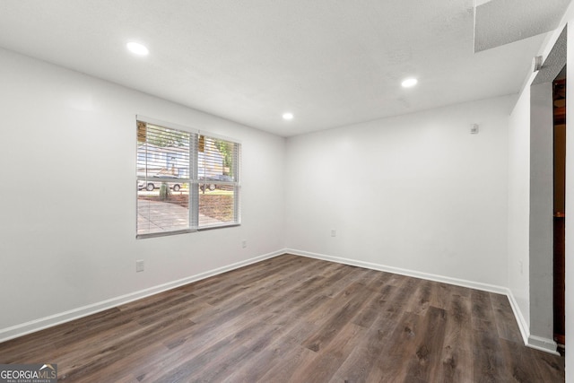 unfurnished room with dark hardwood / wood-style floors