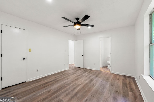 unfurnished bedroom with ceiling fan, ensuite bathroom, and light hardwood / wood-style flooring