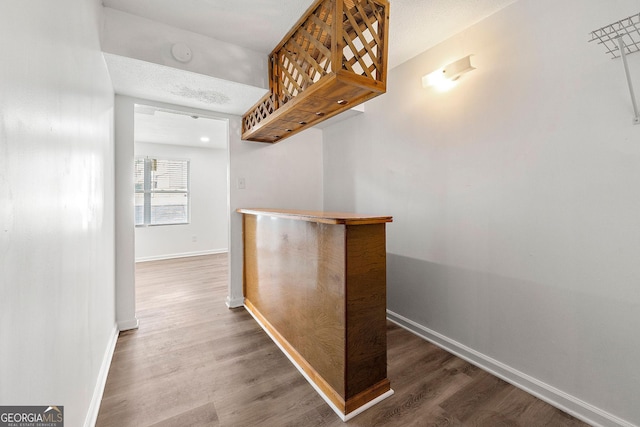 corridor featuring hardwood / wood-style floors