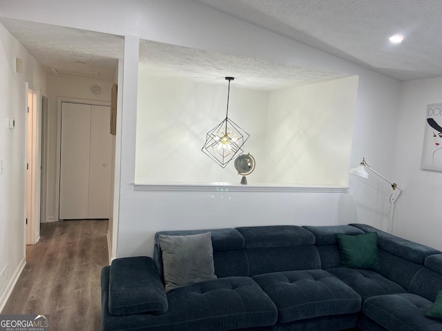 living room with hardwood / wood-style flooring and a textured ceiling