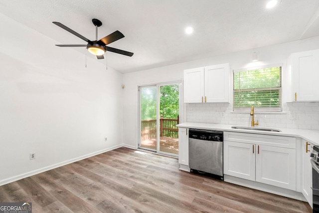 kitchen featuring stainless steel appliances, backsplash, white cabinetry, and sink