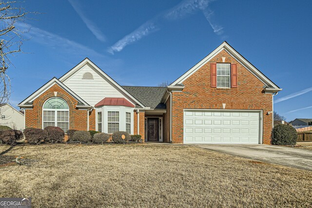 front of property with a garage and a yard