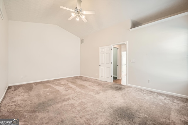 empty room with ceiling fan, carpet flooring, and lofted ceiling