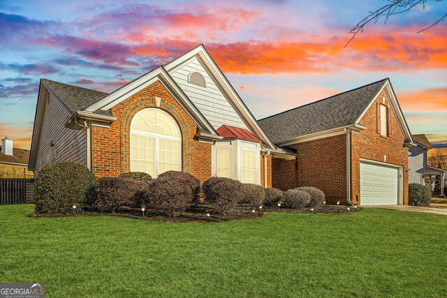 front facade with a front yard and a garage