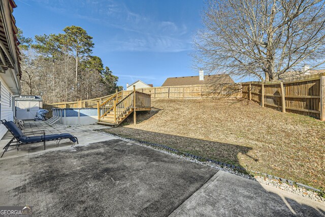 view of yard with a storage unit and a patio