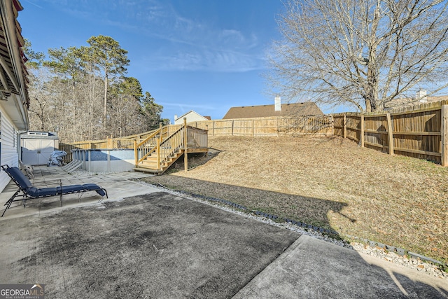 view of yard with a patio area, a fenced backyard, and a fenced in pool