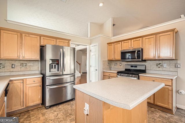 kitchen featuring tasteful backsplash, appliances with stainless steel finishes, and a center island