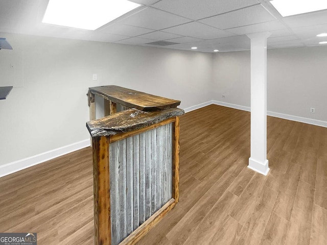 bar featuring hardwood / wood-style flooring and a drop ceiling