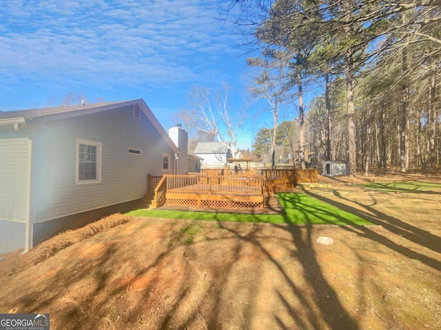 view of yard with a wooden deck