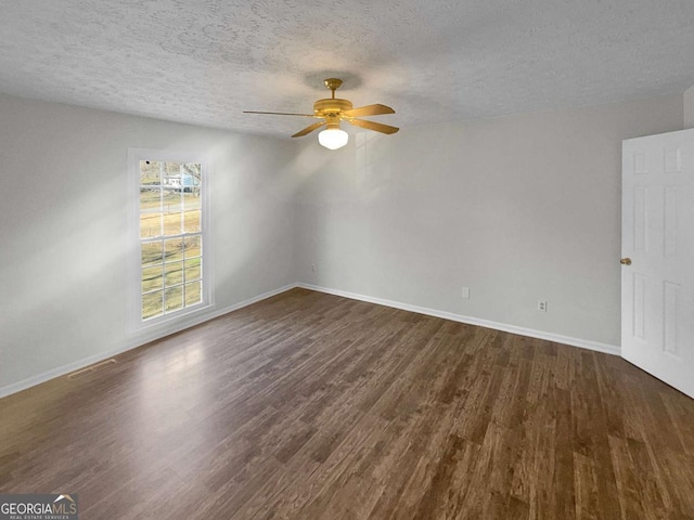 unfurnished room featuring ceiling fan, a textured ceiling, and dark hardwood / wood-style flooring