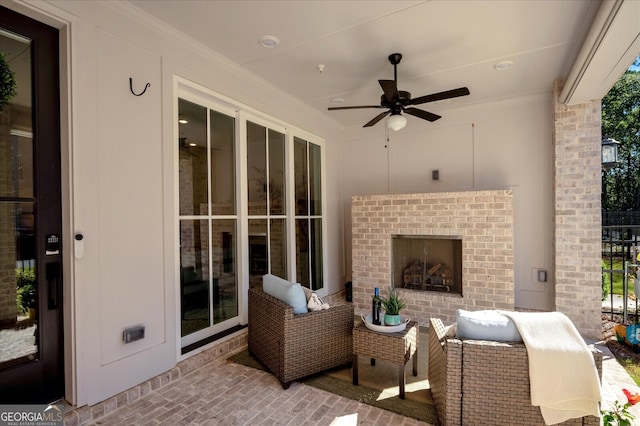 view of patio featuring ceiling fan and an outdoor brick fireplace