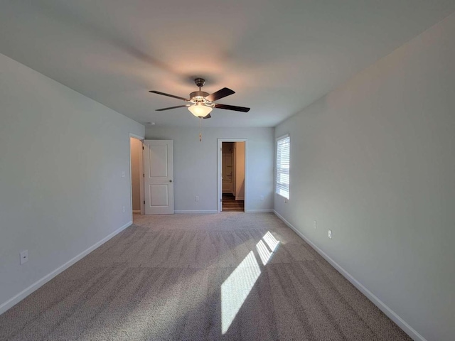 carpeted spare room with ceiling fan