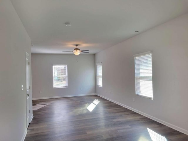 spare room with dark hardwood / wood-style flooring and ceiling fan