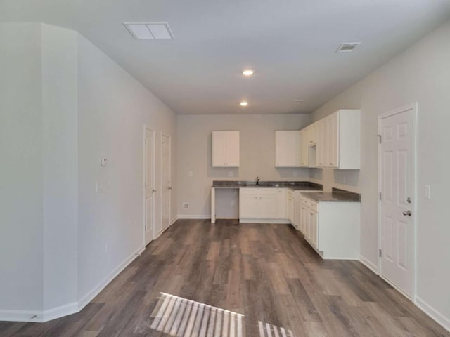 kitchen featuring white cabinetry, sink, and dark hardwood / wood-style flooring