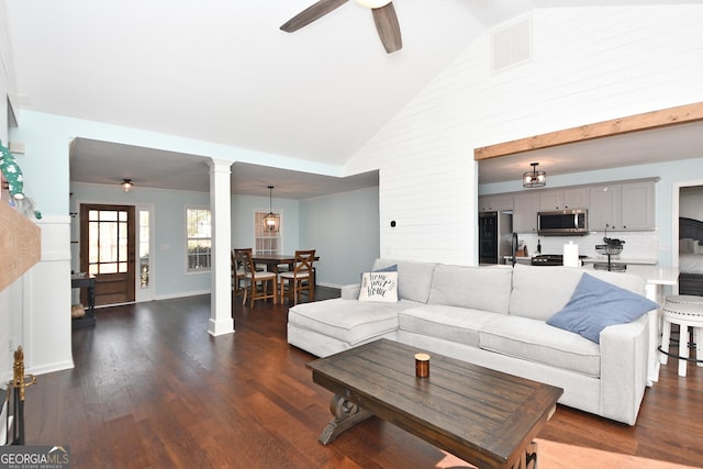 living room with dark wood-type flooring, ceiling fan, and high vaulted ceiling