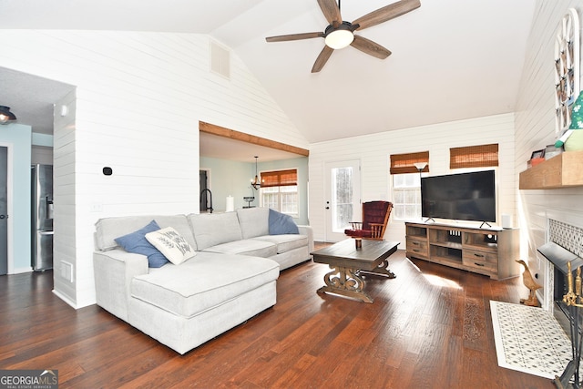 living room with a brick fireplace, dark hardwood / wood-style floors, high vaulted ceiling, and ceiling fan