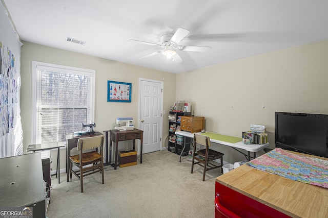 carpeted office featuring ceiling fan